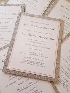 pink and silver glittered wedding programs are laid out on top of each other with matching envelopes