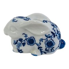 a blue and white elephant figurine with flowers on it