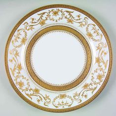 a white and gold plate with an ornate design