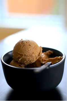 a bowl filled with ice cream on top of a table