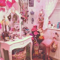 a room filled with pink furniture and lots of decorations