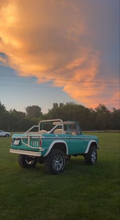 an old pick up truck parked in the grass