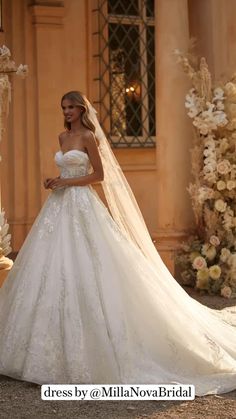 a woman in a wedding dress standing outside