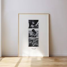 a framed photograph sitting on top of a hard wood floor next to a white wall