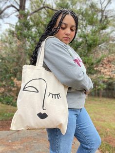 These totes were hand painted by Raven Maureen at her in-home studio. It is a great bag for everyday use - like going to run errands, going to an outdoor Saturday market etc.The tote features an abstract painting on one side of the bag. The tote is a natural canvas color and material.  Here are the specs:  15 inches x 15.5 inches  The model is 5'2'' wearing the tote in the listing.  Straps are 23 inches long each **You must select which option of tote bags that you want to purchase.** Artistic Canvas Tote Bag For Daily Use, Artsy Hand Painted Canvas Bag For Everyday, Artsy Hand Painted Canvas Bag For Daily Use, Artsy Everyday Use Canvas Tote Bag, Artsy Hand-painted Canvas Bag For Daily Use, Artistic Everyday Shoulder Bag, Artsy Canvas Tote Bag For Daily Use, Artsy Hand Painted Tote Canvas Bag, Artsy Hand Painted Shoulder Bag For Daily Use