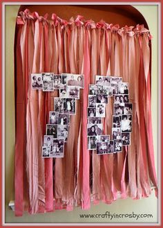 a pink curtain with pictures hanging on it's side and the word love spelled out in