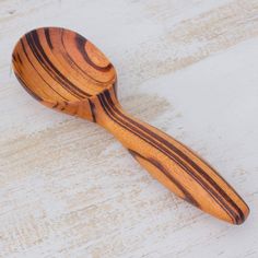 a wooden spoon sitting on top of a white table