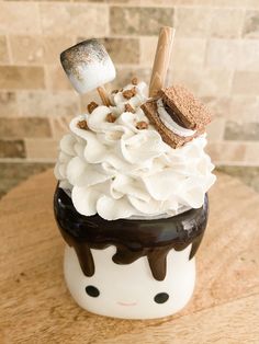 an ice cream sundae with marshmallows, whipped cream and chocolate sauce