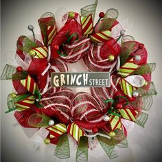 a red and green wreath with the words grin street on it