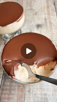 two desserts with chocolate frosting and ice cream in them on a wooden table