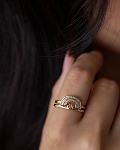 a woman's hand with a gold ring on her finger and diamond set in the middle