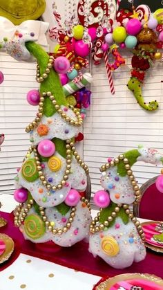 a christmas tree decorated with candy and candies in pink, green, yellow and white