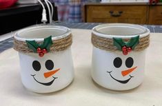 two mason jars decorated to look like snowmen