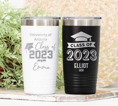 two personalized tumblers are sitting on a shelf