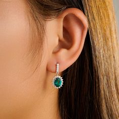 Each of these eye-catching drop earrings features a single sapphire surrounded by a blossom halo of brilliant diamonds for a look that’s both colorful and chic. Style ID: E210061Metal: S925 SilverMetal Color: WhiteRhodium Finish: YesStone(s): Lab Grown EmeraldCenter Stone T.W.: 0.5ct/1ct/1.5ct/2ctStone Dimension: 4x6mm/5x7mm/6x8mm/7x9mmStone Shape: OvalStone Color: Blue and WhiteStone Setting: Prong Set, PavéPictured: 5x7mm Oval Cut Sapphire Sapphire Earrings Drop, Gold Emerald Earrings, Green Stone Earrings, Blue Stone Earrings, Emerald Green Stone, Paradise Wedding, Emerald Earrings Drop, Halo 1, Jewelry Workshop