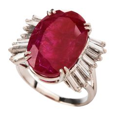 This chic ruby and diamond cocktail ring is crafted in solid platinum, weighing 9.2 grams and 17mm x 9mm high. Showcasing a prominent GIA lab reported oval shaped, prong-set red ruby with no indications of heating, weighing approximately, 9.10 carats and measuring 17.34 x 11.80 x 5.54mm. Further accented by 16 baguette diamonds prong-set at the sides, collectively weighing approximately 0.90 carats, graded H-I color and VS1 clarity. Currently a US size 5.75 and in excellent condition. This purch Pendulum Earrings, Blue Diamond Engagement Ring, Burmese Ruby, Ruby And Diamond Ring, Red Jewelry, Diamond Cocktail Rings, Ruby Jewelry, No Heat, Emerald Engagement Ring