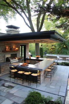 an outdoor kitchen and dining area is shown