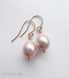 "Genuine champagne pink freshwater pearl earrings ~ 100% sterling silver, 14k gold fill or rose gold fill ~ Shimmery genuine freshwater pearls - Choose your size ~ Total earring dangles just about 1 1/4 - 1 1/2 inches long (35mm) ~ Ear wires are sterling silver, 14k gold fill or rose gold fill ~These earrings are handmade, made to order, and packaged for you See our matching champagne pearl items: https://www.etsy.com/listing/225858095/champagne-pearl-necklace-pink-pearl https://www.etsy.com/lis Elegant Pink Teardrop Pearl Earrings, Rose Gold Dangle Pearl Earrings In Sterling Silver, Rose Gold Sterling Silver Dangle Pearl Earrings, Classic Pink Pear Shaped Jewelry, Elegant Pink Gold Hypoallergenic Jewelry, Classic Pink Pear-shaped Jewelry, Elegant Hypoallergenic Pink Gold Jewelry, Pink Teardrop Pearl Earrings For Wedding, Pink Pearl Charm Wedding Earrings