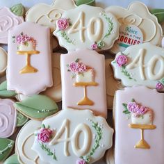 decorated cookies are arranged in the shape of flowers and candles for an anniversary or special occasion