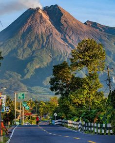 a large mountain towering over a city street