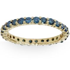 a yellow gold ring with blue sapphire stones