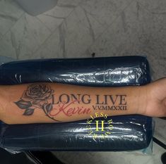 a person's arm with a rose tattoo on it and the words long live kevin