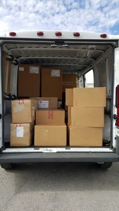 the back end of a van filled with boxes