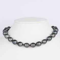 This one-of-a-kind necklace is composed of gorgeous drop-shaped Tahitian pearls measuring 12.0-12.9 mm in size and is approximately 18 inches in length. The pearls feature dark bodycolor with tones of dark green and dark silver. Your Tahitian strand will arrive double knotted on black silk. The knotting protects your pearls from rubbing against each other, and if your necklace ever breaks, you won't lose a single pearl. The necklace is finished with a solid, 14 karat clasp with a safety catch fo Black Single Strand Tahitian Pearl Necklace, Black Tahitian Pearl Single Strand Necklace, Formal Black Tahitian Pearl Necklace, Formal Single Strand Teardrop Pearl Necklace, Pearl Drop Necklace, Jewelry Appraisal, Pearl Types, Tahitian Pearls, Gold Polish