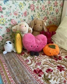 several stuffed animals sitting on top of a bed