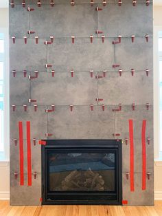 a fireplace with red tape on it and a fire place in front of the mantel