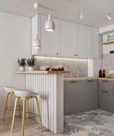 a kitchen with two stools in front of the counter