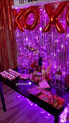 the table is set up with balloons and candy