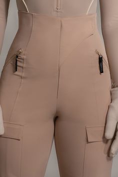 Meet our Tan Nyah Nylon Utility Pants – crafted in our nylon fabric for utility and comfort. With a high waist, hidden zipper closure, and handy side zipper pockets to secure your essentials. Versatile cargo pockets and stylish leg straps with velcro closures add both functionality and style. Pair with our Rise Up Zip Front Bodysuit for the full look. Water resistant. No stretch. Single lined. Materials: (Self) 92% Nylon 6% Spandex (Contrast) 60% Polyester 40% ViscoseLength: (inseam) 32.5 in. (w Leg Straps, Utility Pants, Full Look, Nylon Fabric, Hidden Zipper, Side Zipper, Zipper Pocket, High Waist, Water Resistant