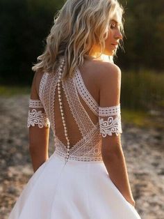 the back of a woman's wedding dress with pearls on it and an instagram