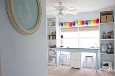 a room with white shelves and colorful curtains