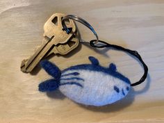 a keychain with a blue and white cat on it