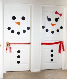 two white doors decorated with black polka dots and a snowman's head on them