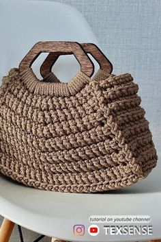 a crocheted purse sitting on top of a white chair