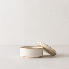 two white bowls sitting next to each other