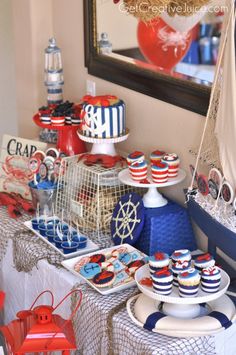 a table topped with plates and cakes covered in red, white and blue icing