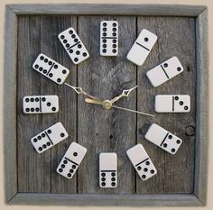 a clock made out of dominos sitting on top of a wooden table