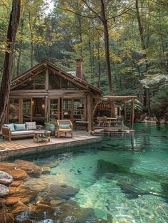 a cabin in the woods is surrounded by water and rocks, with an outdoor seating area next to it