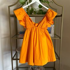 Cotton Blend. Made In China. Hand Wash Recommended. Fully Lined. Hidden Side Zipper With Back Tie Closure. Ruffle Sleeves. Side Seam Pockets. Worn Once. Adorable! For Love And Lemons Clementine Dress, Orange V-neck Mini Dress For Vacation, Orange V-neck Sundress, Yellow V-neck Mini Dress With Ruffle Hem, Orange Rayon V-neck Dress, Lemon Dress, For Love & Lemons, Love And Lemons, Ruffle Sleeves