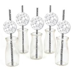 six clear glass vases with black and white striped paper straws in the middle