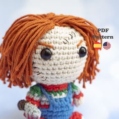 a small crocheted doll with orange hair