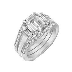 an emerald cut engagement ring set with diamond accents on the shoulders and sides, in 18k white gold