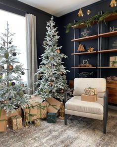 a living room decorated for christmas with presents on the floor and a tree in the corner