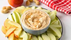 an apple slice platter with peanut butter and apples