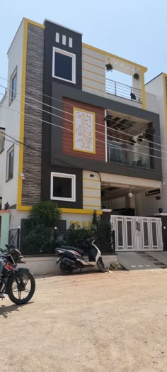 two motorcycles parked in front of a multi - story building