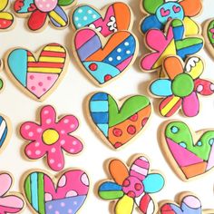 decorated cookies are arranged in the shape of hearts